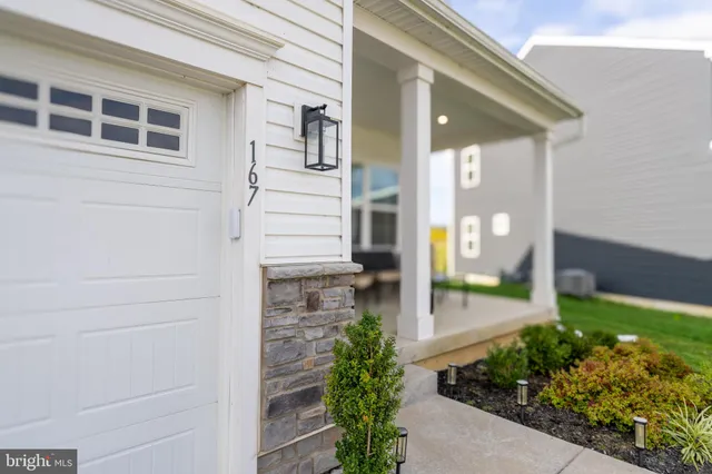 a front view of a house with a garden