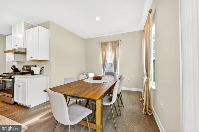 a view of a hallway with wooden floor and closet