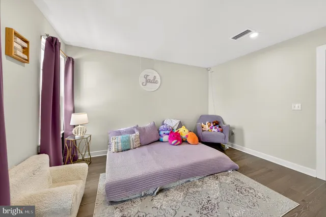 a spacious bedroom with a bed and a large window