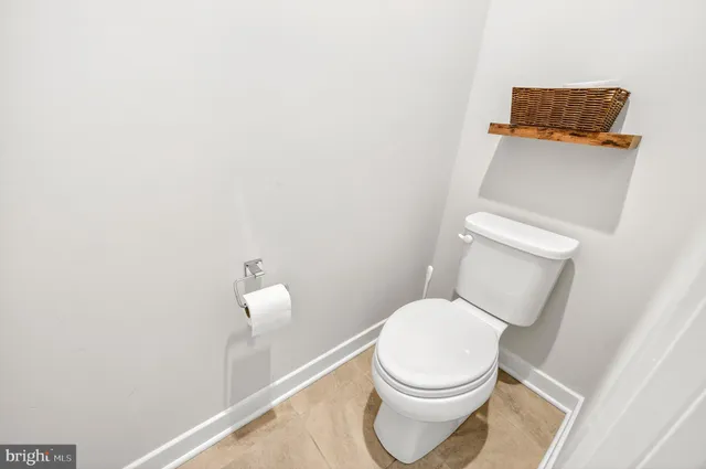 a view of a backyard with table and chairs potted plants and large tree