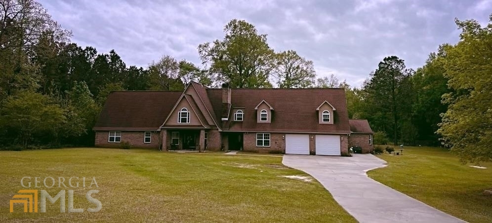 198 Devoe Smith Road Cochran, GA 31014 - Photo 1 of 1 a front view of a house with a yard