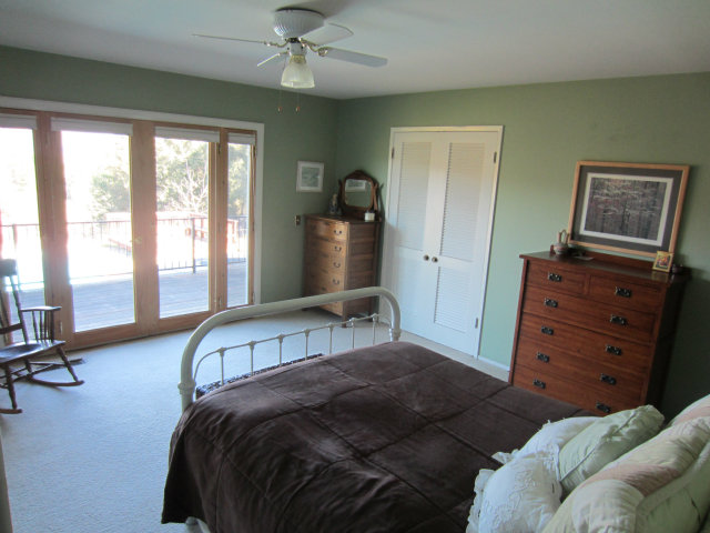 419 Poppy Hill Road Watsonville, CA 95076 - Photo 16 of 25 a bedroom with a bed and wooden floor