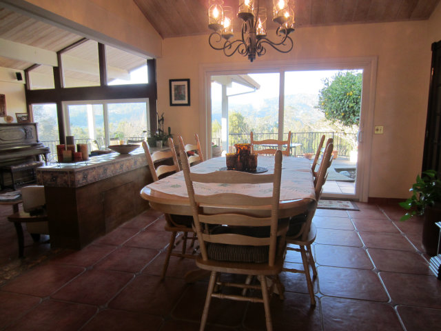 419 Poppy Hill Road Watsonville, CA 95076 - Photo 23 of 25 a view of a dining room with furniture a chandelier and large windows