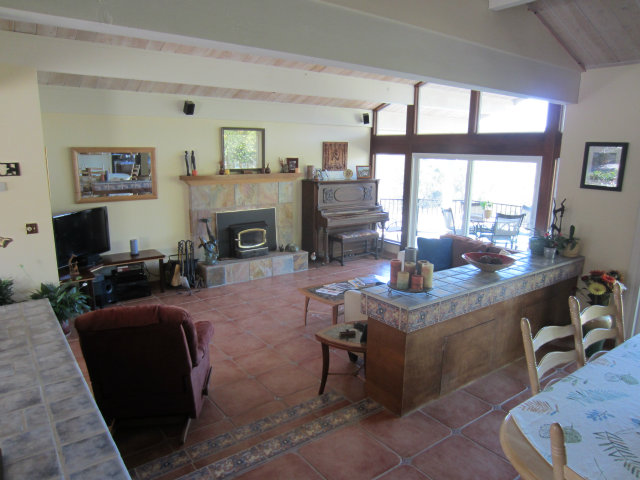 419 Poppy Hill Road Watsonville, CA 95076 - Photo 6 of 25 a living room with furniture a fireplace and a large window