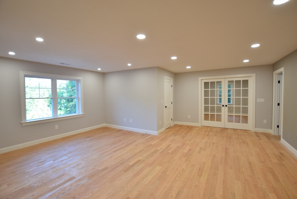 348 Boston Road Chelmsford, MA 01824 - Photo 23 of 42 a view of an empty room with a window and wooden floor