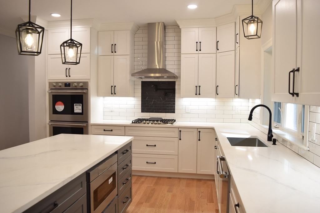 348 Boston Road Chelmsford, MA 01824 - Photo 3 of 42 a kitchen with stainless steel appliances a stove a sink and a refrigerator