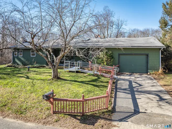 a view of a house with backyard and sitting area