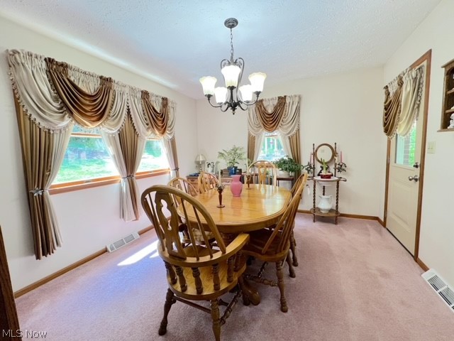 1349 Deer Hill Road Dennison, OH 44621 - Photo 10 of 36 Dining area featuring an inviting chandelier, carpet flooring, and a textured ceiling