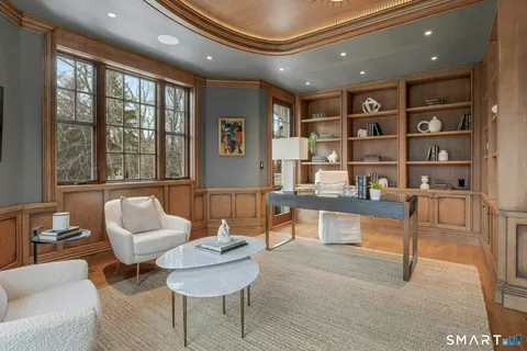 a living room with furniture and a book shelf