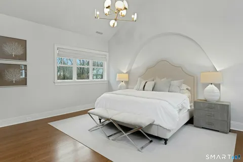 a bedroom with a bed dresser and a window