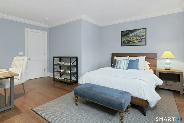 a bedroom with a bed and a chair