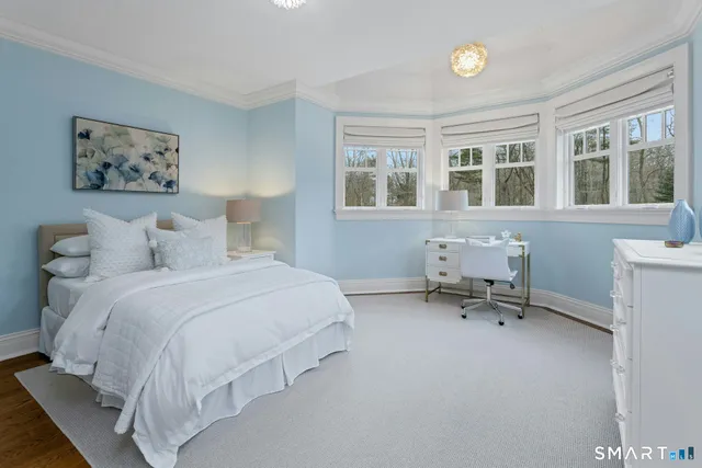 a bedroom with a bed a table and a window