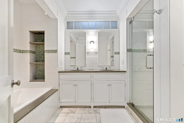 a spacious bathroom with a tub sink and mirror