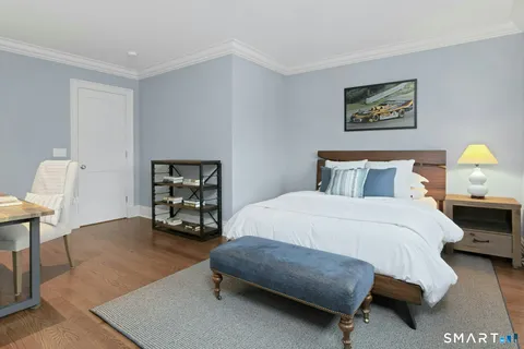 a bedroom with a bed and a chair