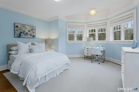 a bedroom with a bed a table and a window