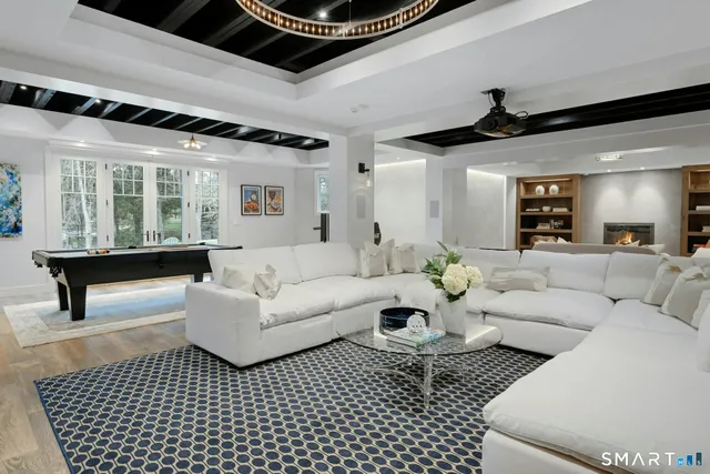 a living room with furniture and a chandelier