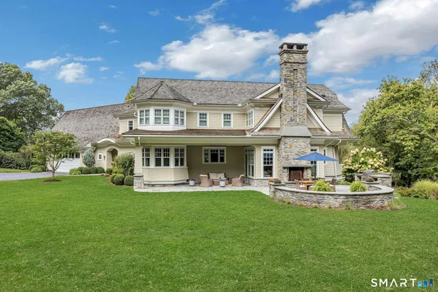 a front view of a house with a yard table and chairs