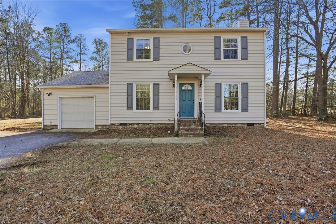 Colonial home with crawl space, driveway, a chimne