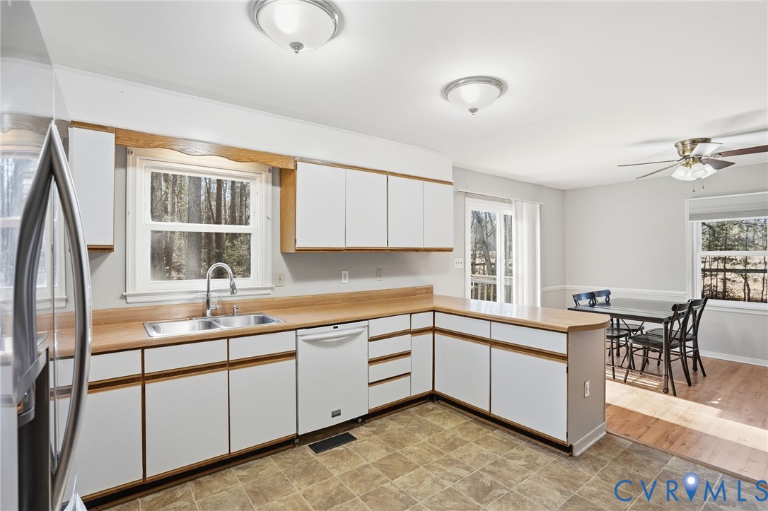 3605 Whitehouse Road Colonial Heights, VA 23834 - Photo 20 of 46 Kitchen featuring white cabinetry, a peninsula, fr