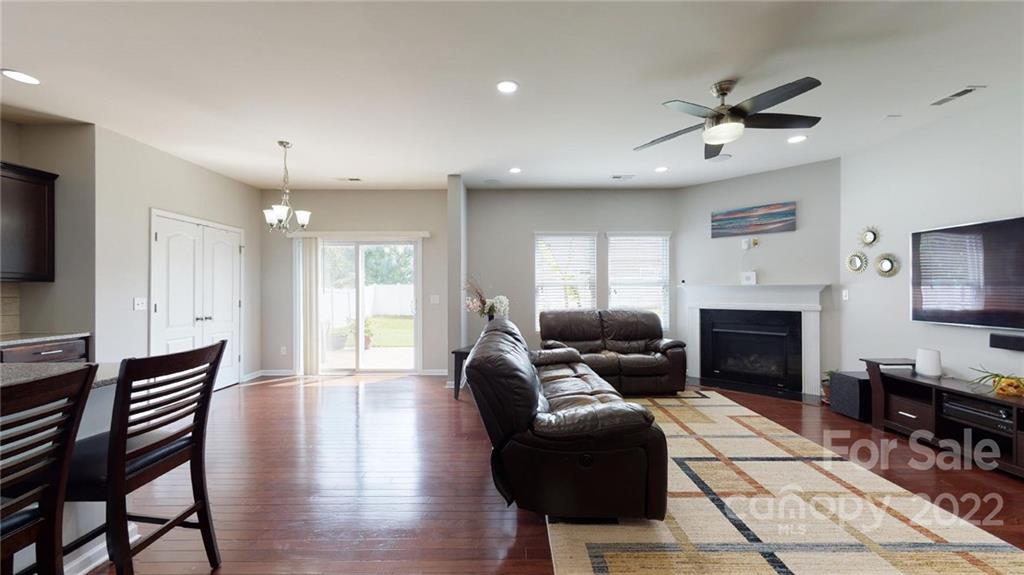 1549 Spring Blossom Trail Fort Mill, SC 29708 - Photo 14 of 45 a living room with furniture a fireplace and a flat screen tv