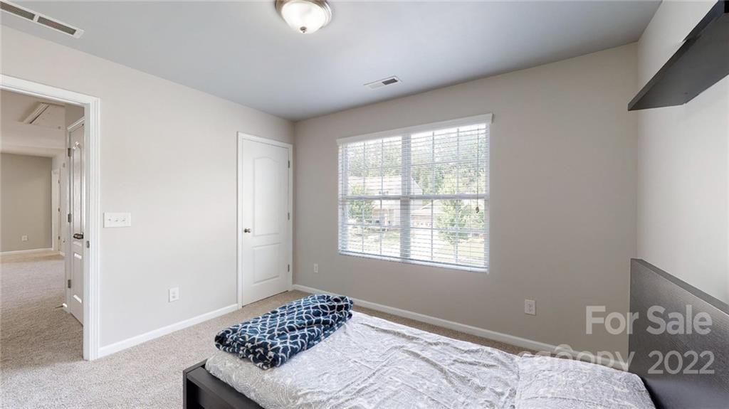 1549 Spring Blossom Trail Fort Mill, SC 29708 - Photo 34 of 45 a bedroom with a bed and a window