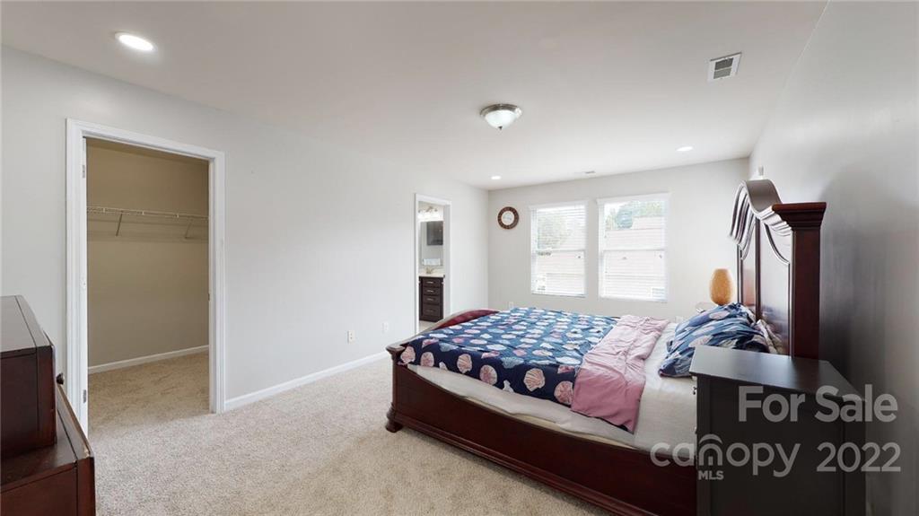 1549 Spring Blossom Trail Fort Mill, SC 29708 - Photo 39 of 45 a bedroom with a bed and wooden floor