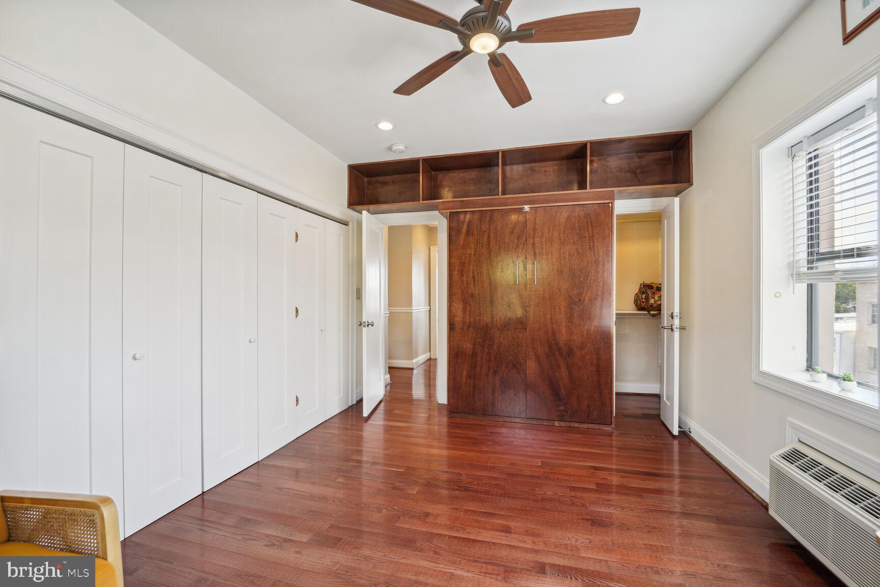 315 Evarts Street Northeast, Unit 210 Washington, DC 20002 - Photo 7 of 17 a view of an empty room with wooden floor and a window