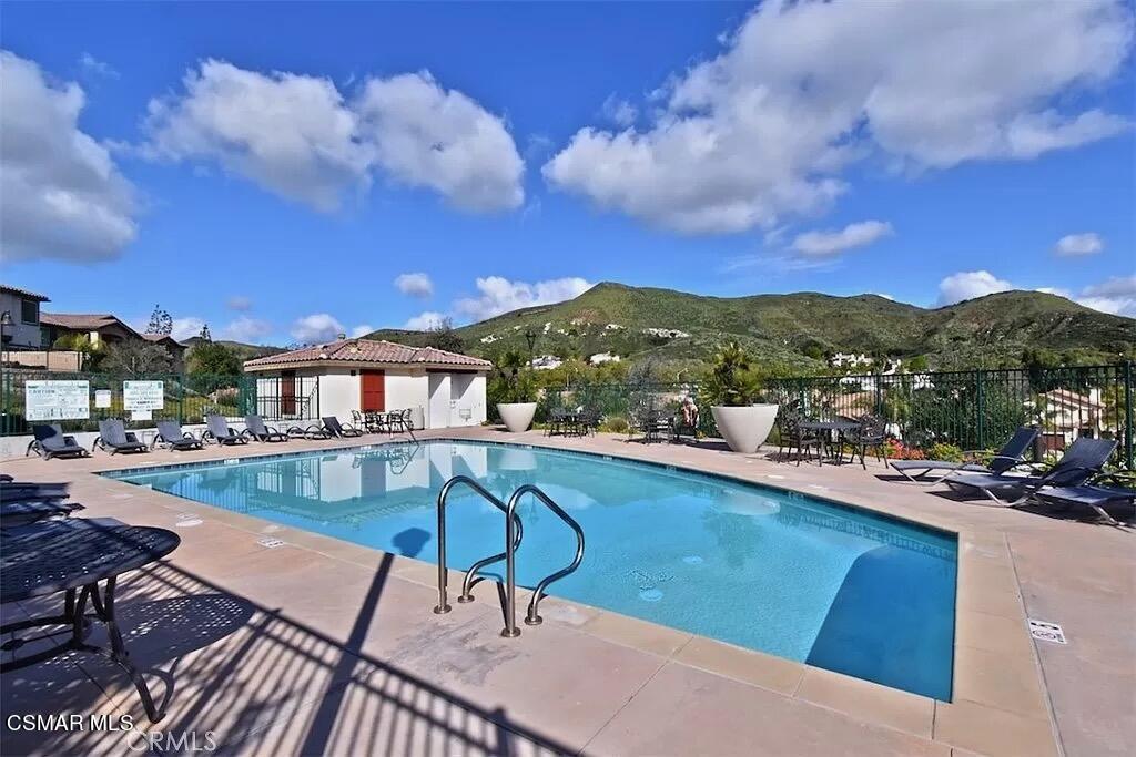 207 Morro Way, Unit 3 Simi Valley, CA 93065 - Photo 28 of 31 a view of a swimming pool with a table and chairs