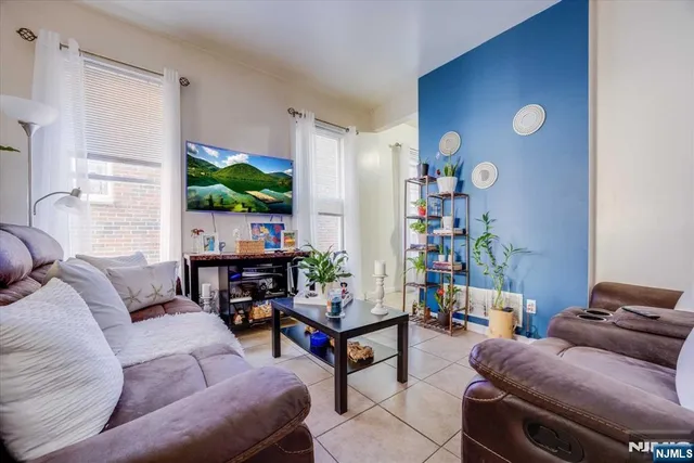 a living room with furniture and a potted plant