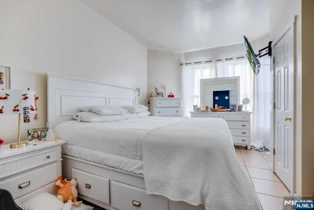 a bedroom with a bed and a fireplace