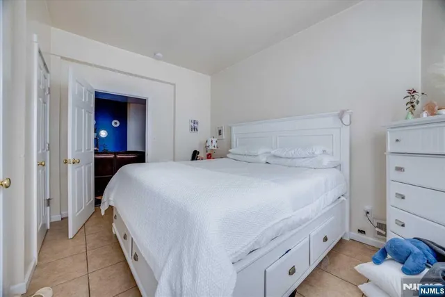 a bedroom with a bed and a closet