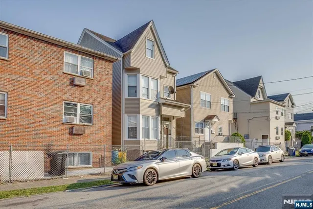 a view of a white car parked in front of a building