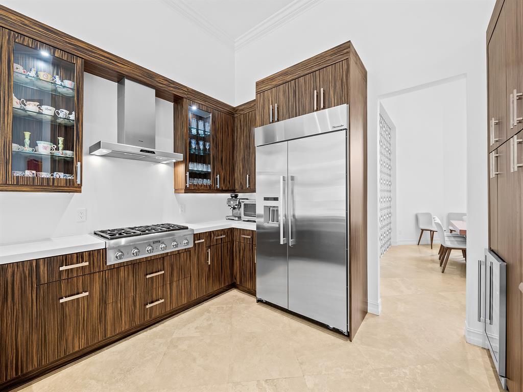 731 Coconut Palm Terrace Plantation, FL 33324 - Photo 12 of 48 a kitchen with stainless steel appliances granite countertop a refrigerator a stove and a sink with cabinets