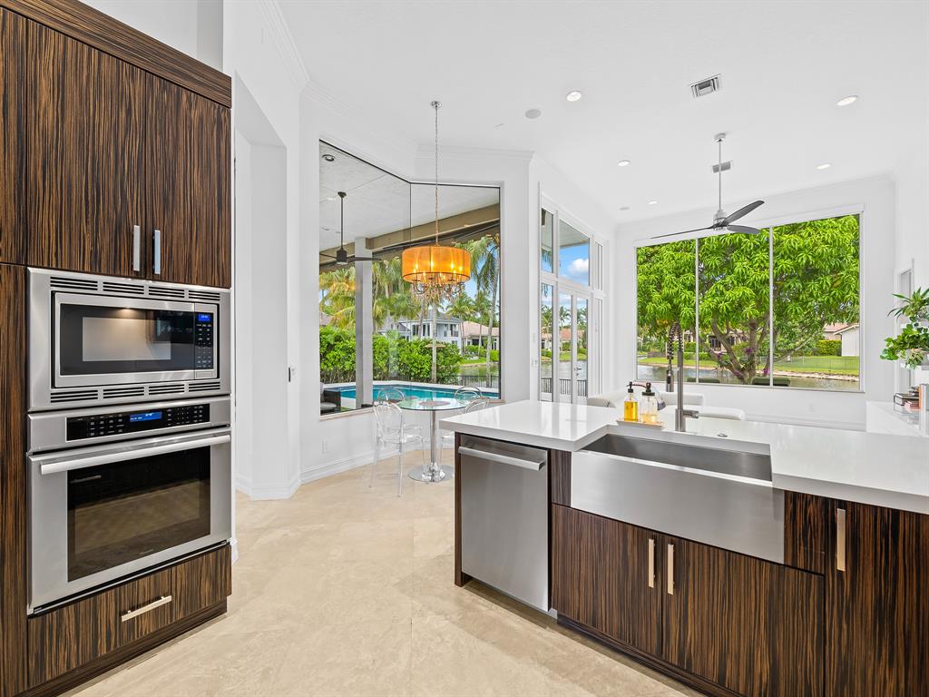 731 Coconut Palm Terrace Plantation, FL 33324 - Photo 13 of 48 a kitchen with kitchen island a sink stove and microwave