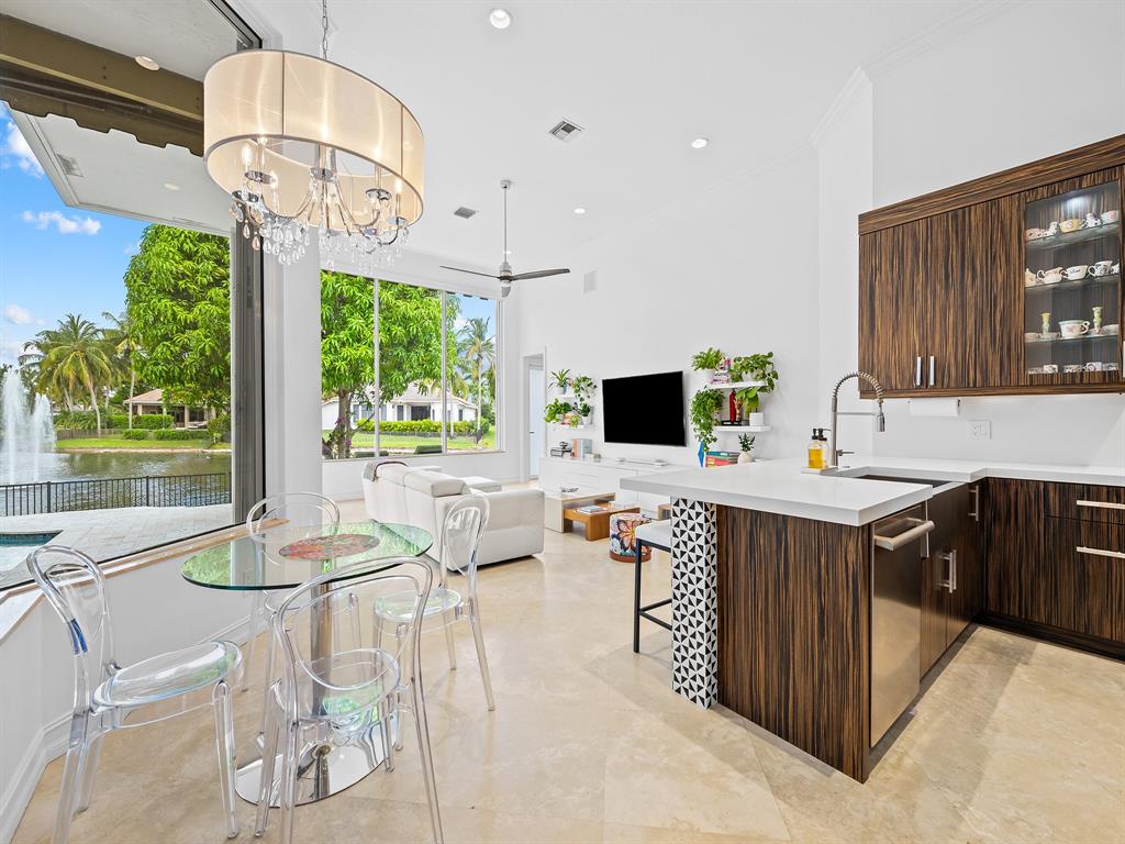 731 Coconut Palm Terrace Plantation, FL 33324 - Photo 14 of 48 a kitchen with a table chairs and microwave