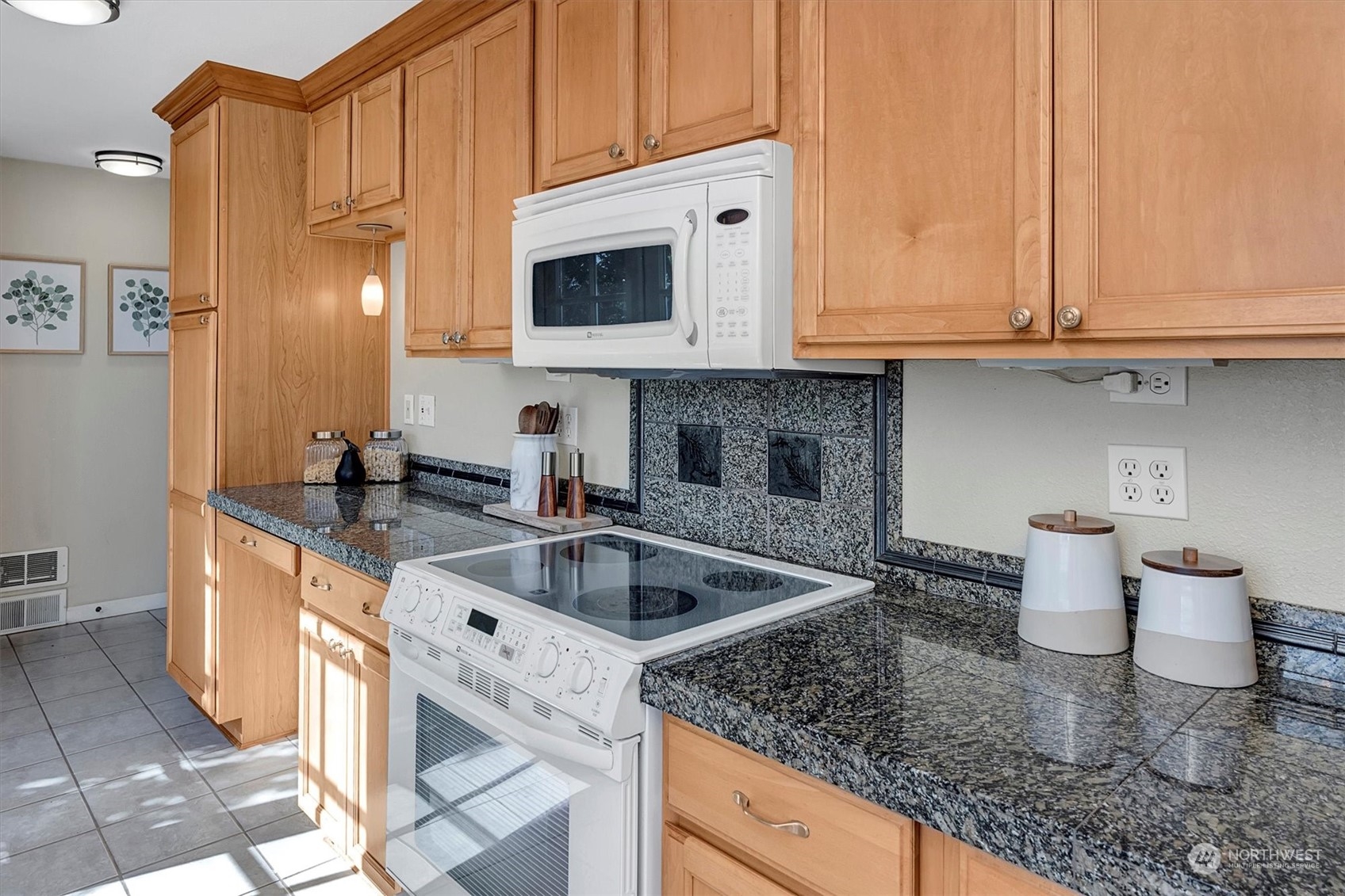 513 Meade Avenue Sumner, WA 98390 - Photo 12 of 35 a kitchen with stainless steel appliances granite countertop a sink and a white cabinets