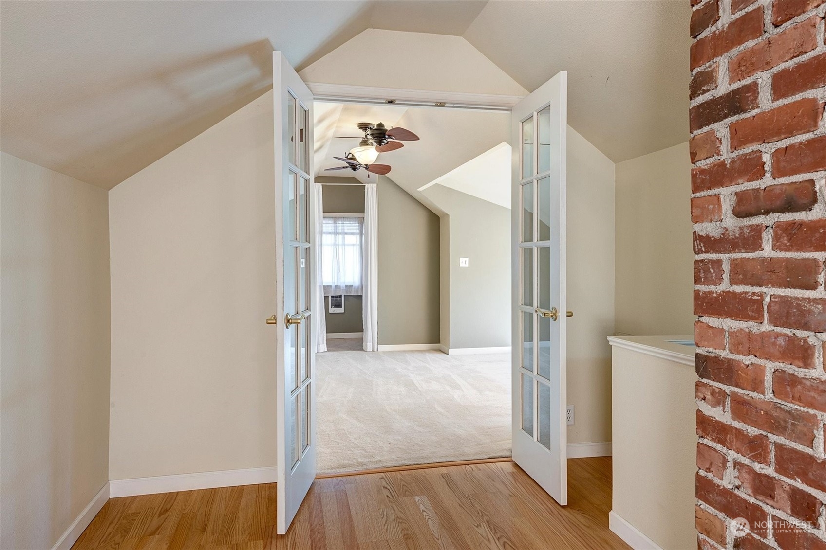 513 Meade Avenue Sumner, WA 98390 - Photo 20 of 35 a view of a hallway with wooden floor and staircase