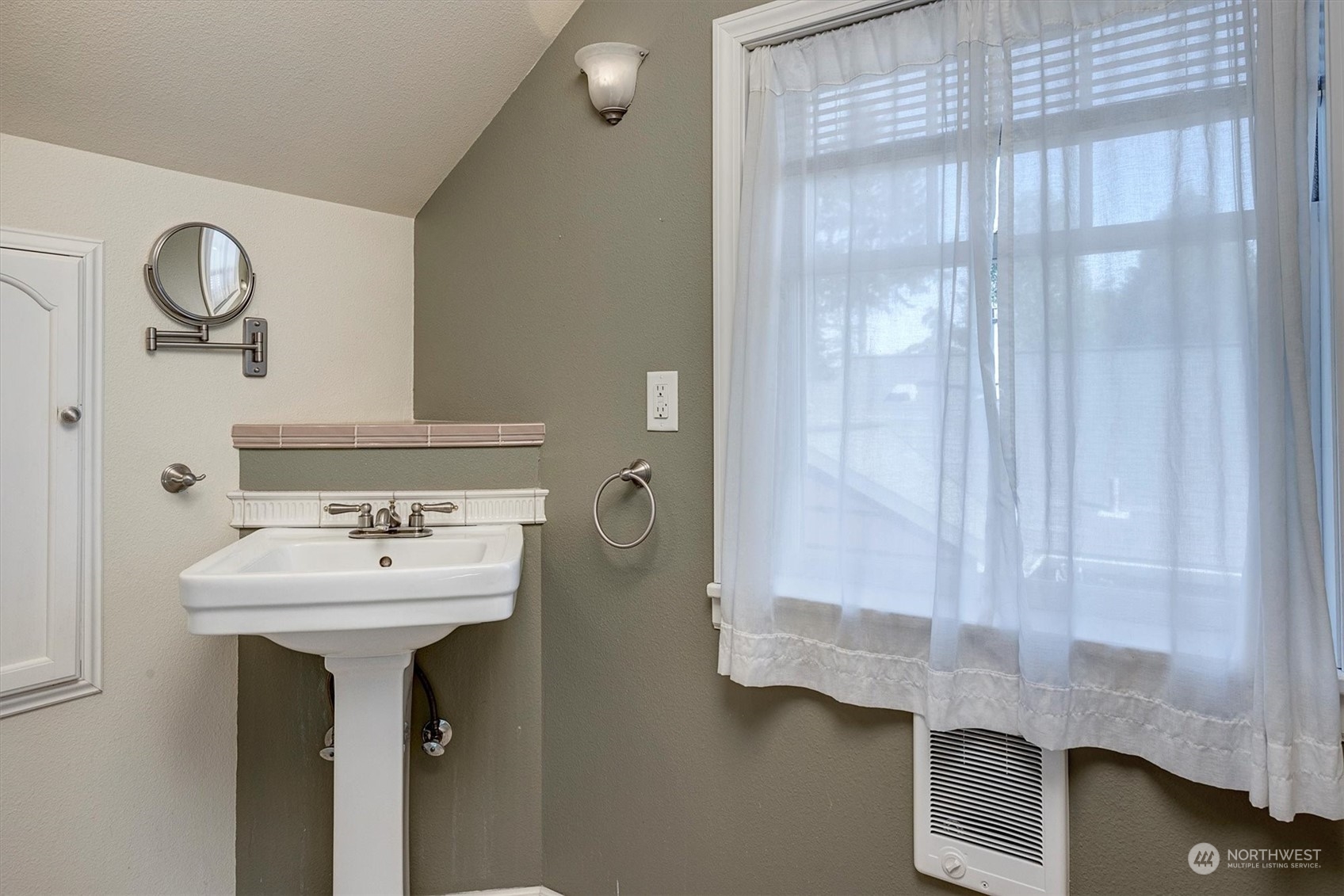 513 Meade Avenue Sumner, WA 98390 - Photo 23 of 35 a bathroom with a sink a mirror and shower