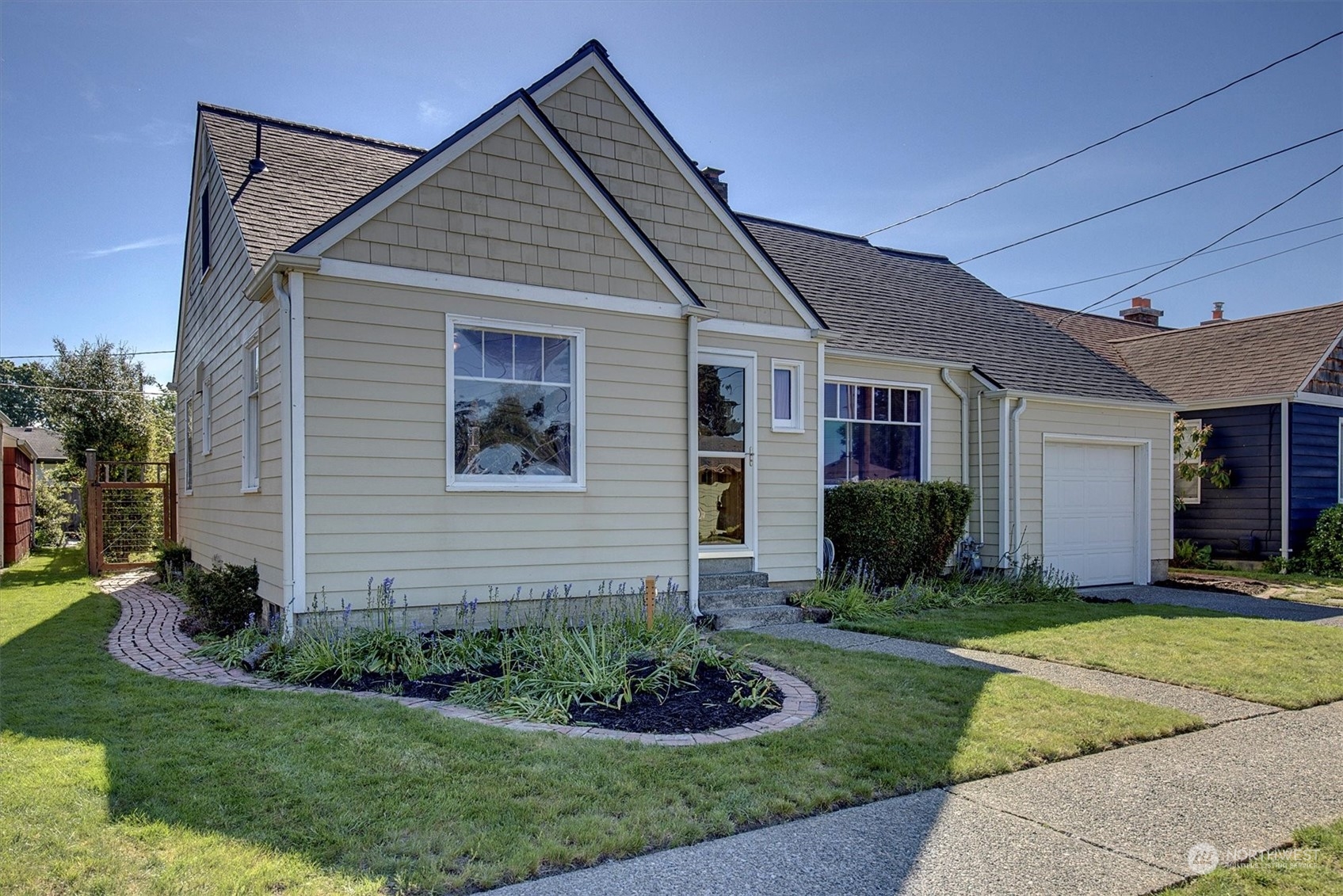 513 Meade Avenue Sumner, WA 98390 - Photo 33 of 35 a front view of a house with a yard and garage