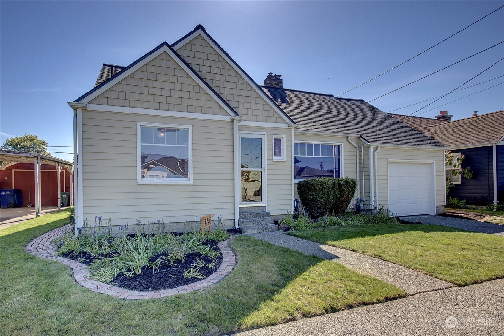 513 Meade Avenue Sumner, WA 98390 - Photo 34 of 35 a front view of a house with a yard and garage