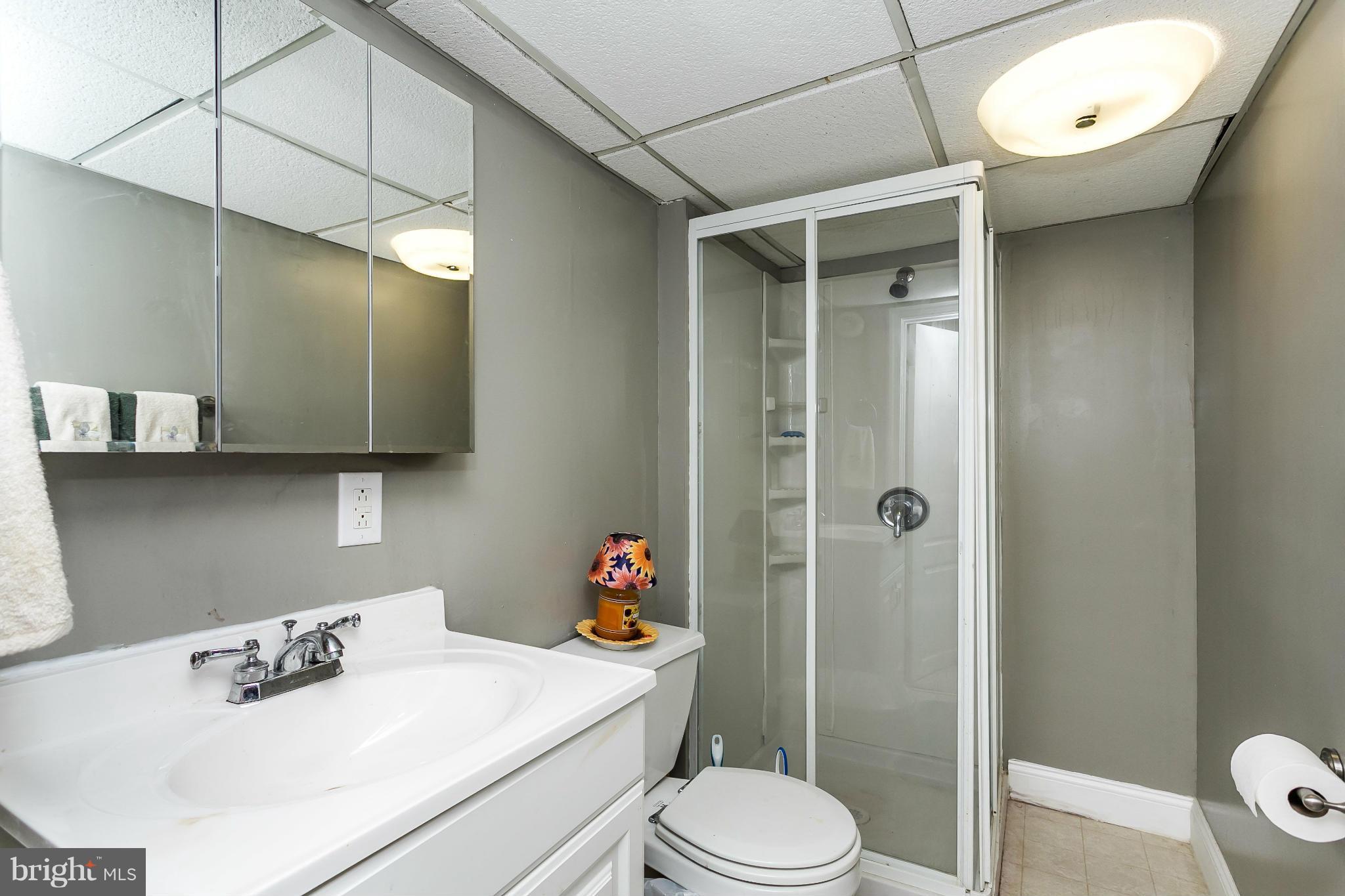 4804 Variation Road Baltimore, MD 21236 - Photo 20 of 27 a bathroom with a sink toilet vanity and shower