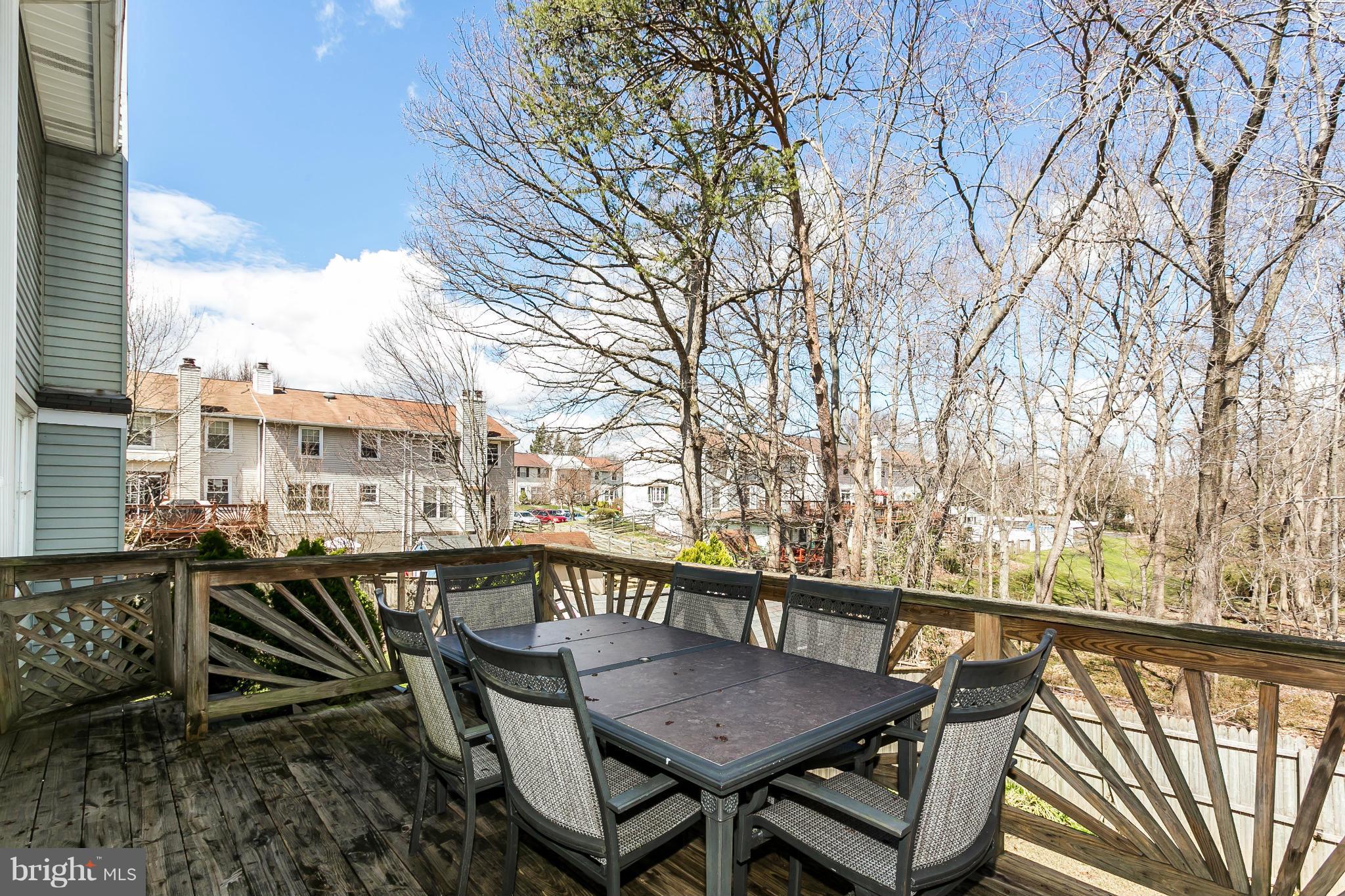 4804 Variation Road Baltimore, MD 21236 - Photo 24 of 27 a balcony of wooden table with chairs and wooden fence
