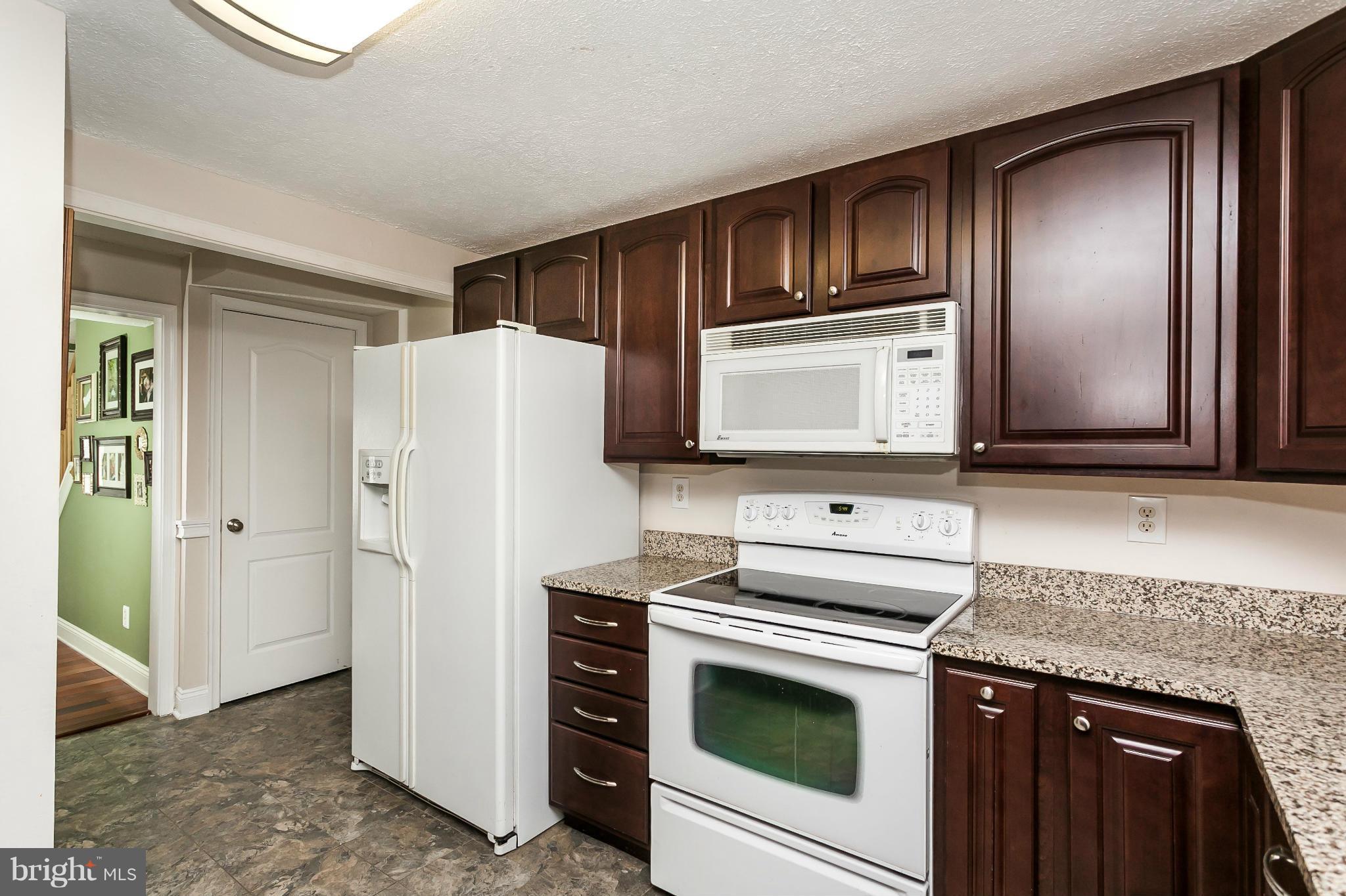 4804 Variation Road Baltimore, MD 21236 - Photo 9 of 27 a kitchen with stainless steel appliances granite countertop a refrigerator stove and sink