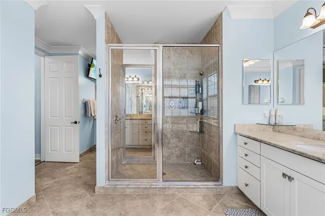 a spacious en suite bathroom with a tub sink and mirror