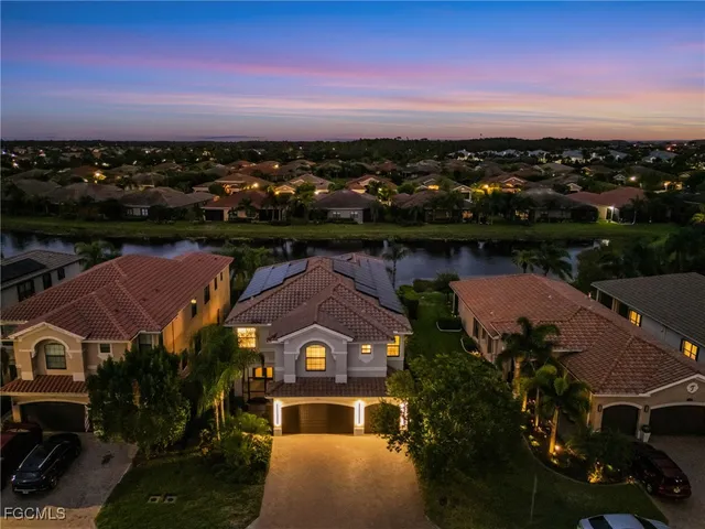 an aerial view of a house with a lake view