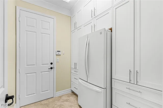 a kitchen with kitchen island white cabinets and white appliances