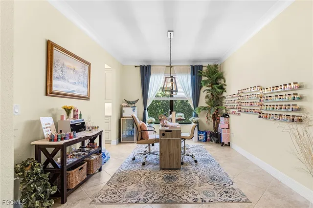 a dining room with furniture a chandelier and window