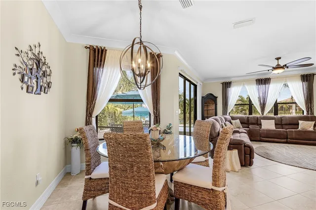 a living room with furniture and large windows
