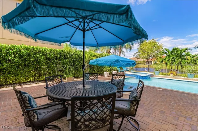 a view of a swimming pool with an outdoor space and seating area