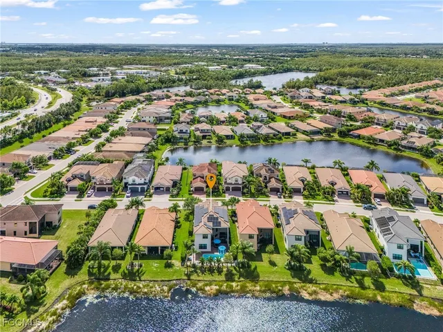 an aerial view of residential houses with outdoor space and river view
